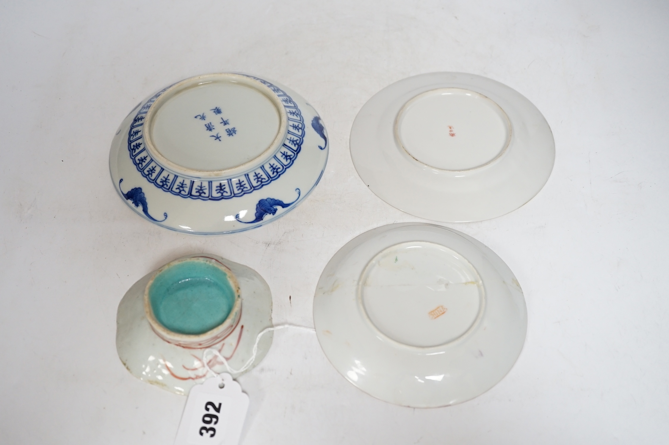 Four Chinese or Japanese porcelain saucers, largest 16.5 cm diameter